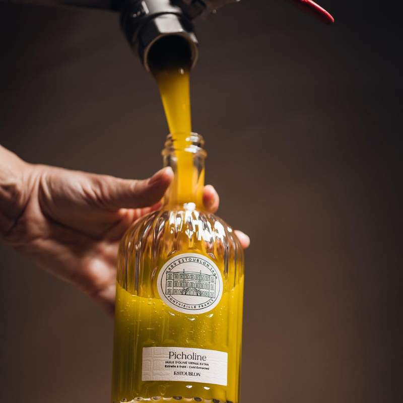 pouring olive oil in a bottle