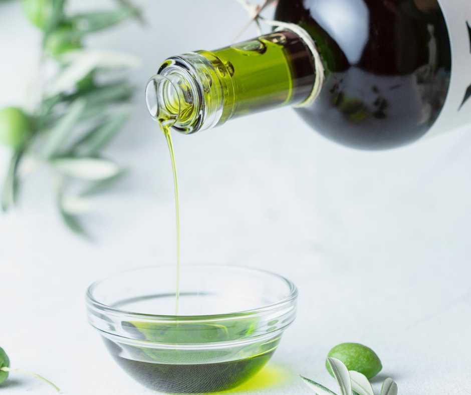 olive oil dropping from a bottle to a plate